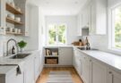 Small kitchen with crisp white cabinets and walls, creating a bright and expansive feel