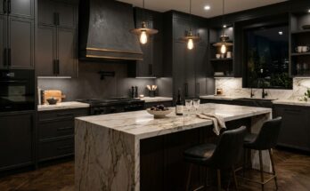 Luxurious dark kitchen with charcoal grey or navy cabinets, matte black hardware, and marble or wood accents