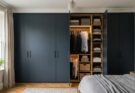 Wall-to-wall built-in wardrobe with Farrow & Ball Railings matte doors and customized interior