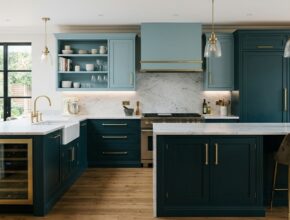 Luxurious kitchen with deep teal base cabinets and lighter teal upper cabinets with brushed brass.