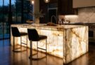 Show-stopping kitchen island made of translucent, backlit onyx or quartzite, glowing with natural patterns.