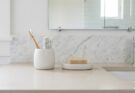 Decluttered bathroom countertop with minimal, organized essentials for a spa-like feel.