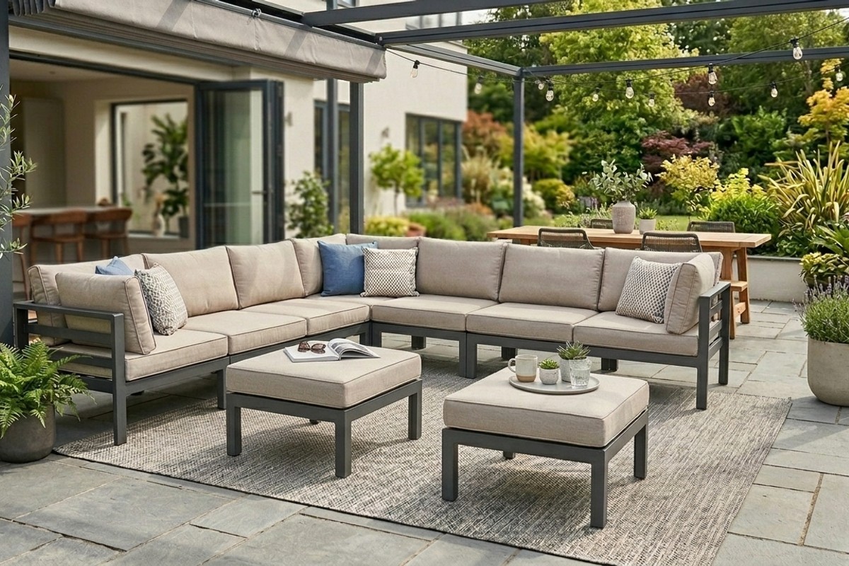 Versatile outdoor furniture on a patio, showing modular sectional sofas and ottomans used as seating and tables