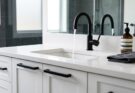 Modern bathroom vanity with matte black faucet and matching cabinet pulls