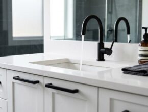 Modern bathroom vanity with matte black faucet and matching cabinet pulls
