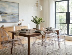 Clear acrylic 'ghost chairs' tucked under a dining table in a small dining room.
