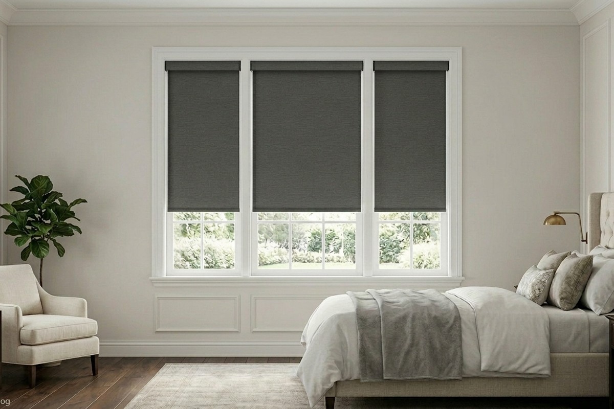 Elegant layered window treatments with blackout roller shades and floor-length, lined drapes in a rich fabric for an upscale bedroom.